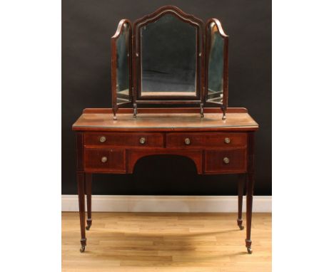 An Edwardian mahogany bow front dressing table, in the George III manner, oversailing top above an arrangement of four satinw