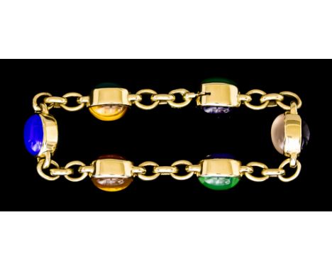 A Modern 18ct Gold Bracelet set with cabochon gem stones, 220mm overall, total gross weight 56.5g The item presents in a cond