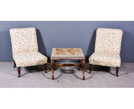 A Pair of Victorian Low Nursing Chairs, upholstered in floral pattern cloth, on turned and fluted legs, and a Victorian stool