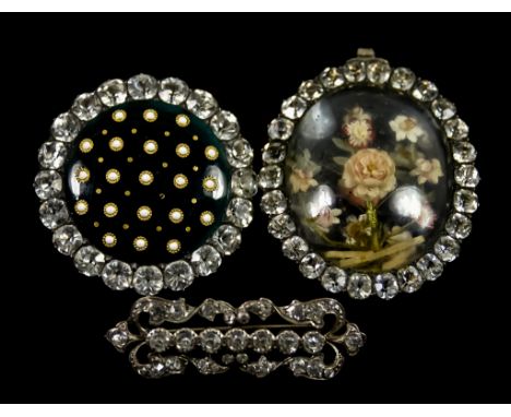 Three Paste Set Silver Brooches, comprising - one encapsulating dried flowers, 45mm x 30mm, set with bail to be worn as neckl
