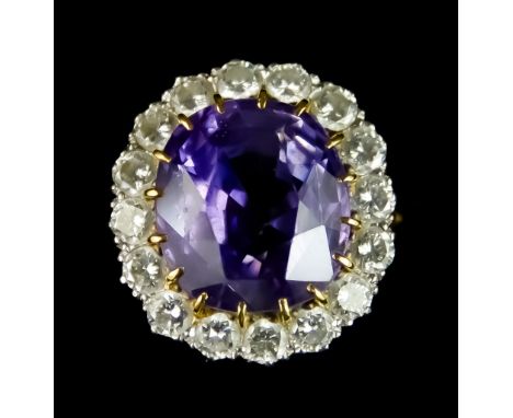 An 18ct Gold Sapphire and Diamond Ring, set with a centre faceted sapphire, approximately 3.5ct, surrounded by brilliant cut 