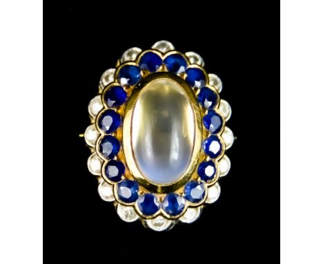 A Yellow Metal Ring, set with a centre cabochon moonstone surrounded by small sapphires and small diamonds, size K, gross wei