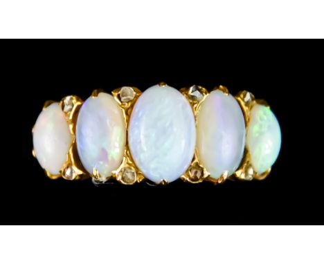 A Yellow Metal Ring, set with five opal stones, size M, gross weight 5.1g Note: Metal unmarked but tests as 18ct Gold