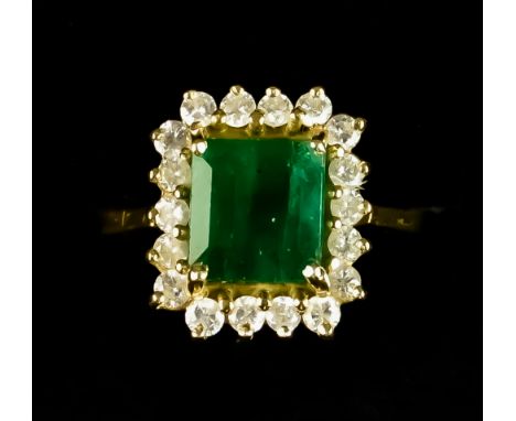 An Emerald and Diamond Ring, set with a centre faceted emerald, approximately 1.5ct, surrounded by small brilliant cut white 