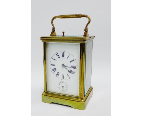 French brass carriage repeat alarm clock, with half hour strike, the back plate numbered 4082, complete with its leather carr