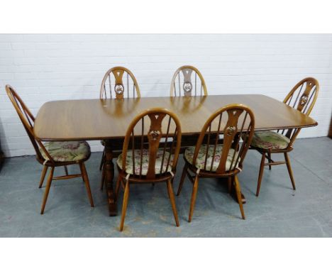 Ercol elm dining suite comprising an extending dining table and set of  six swan back chairs, 76 x 222cm (7) 