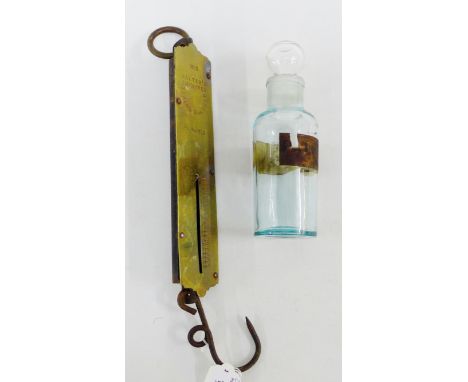 19th century glass pharmacy bottle and stopper, together with a set of Salters No.2 spring balance scales, (2)