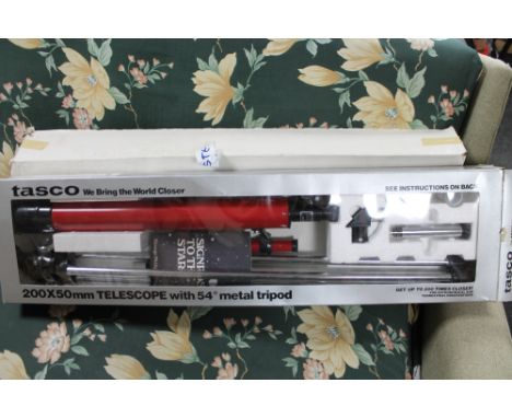 A boxed Tasco telescope 