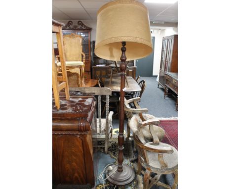 An antique oak standard lamp with shade, height 158 cm