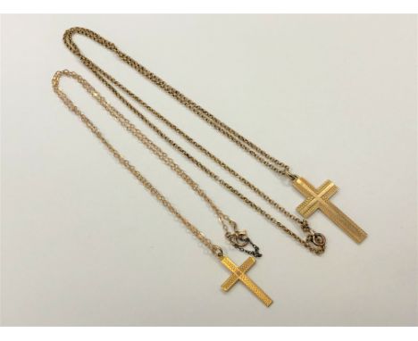 Two 9ct gold crucifix pendants on chains, 9.2g CONDITION REPORT: 9.2g gross. Larger cross 32mm by 20mm with a chain of 55cm. 