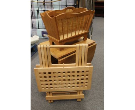 A light oak flap sided table and magazine rack 