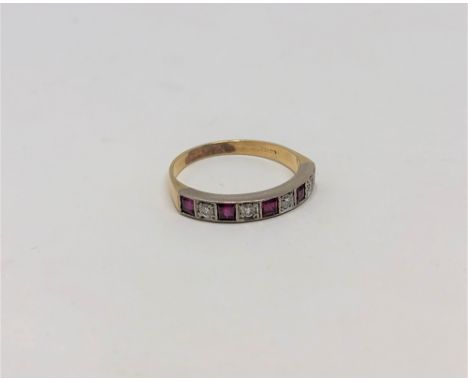 A ruby and diamond half eternity ring, 18CT size O.  CONDITION REPORT: Indistinctly stamped. 2.8g. 