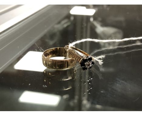 A 9ct gold band ring and a gold sapphire and diamond cluster ring, sizes L and J/K respectively.  CONDITION REPORT: 3.6g gros