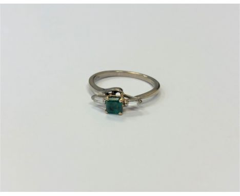 An 18ct gold emerald and diamond ring