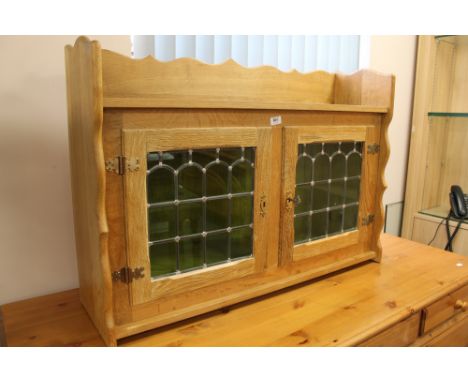 A light oak glazed wall cabinet 