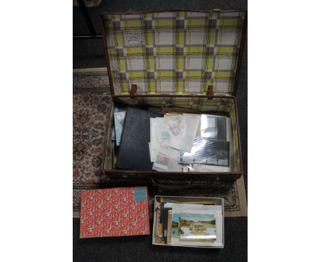 A vintage suitcase containing a large quantity of stamps 