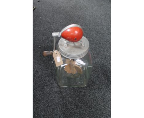 A vintage glass butter churn 
