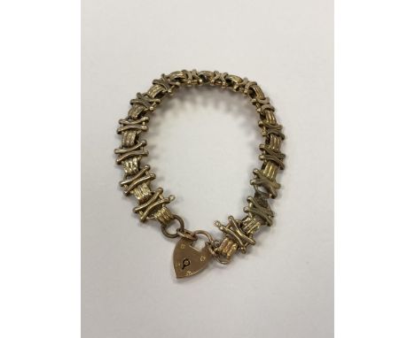 A yellow metal padlock bracelet CONDITION REPORT: The padlock is stamped 9ct. A couple of links do not appear to be gold. Sol