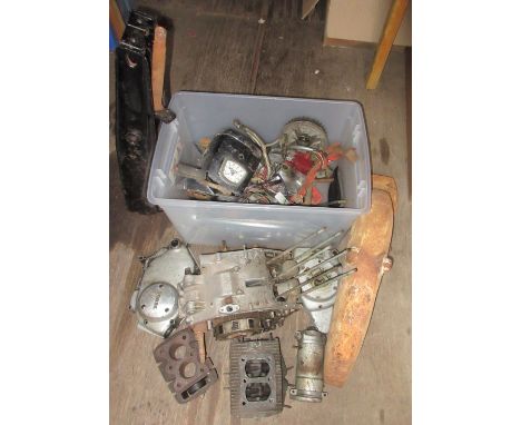 A group of Honda C92 125 cc parts, including forks, headlight cowl, speedo and major engine components