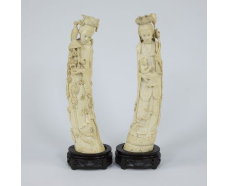 A pair of Japanese ivory sculptures depicting two female goddesses with long robes in a graceful bowed position, Guanyin, sig