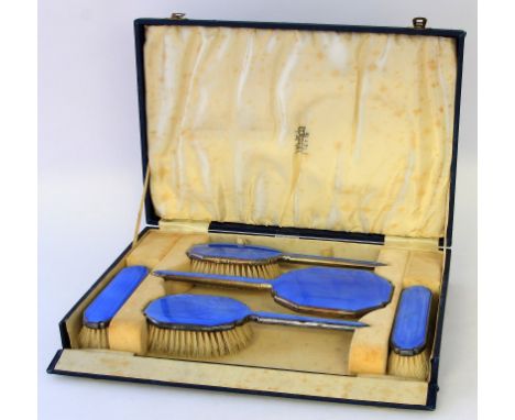 An Art Deco silver and enamel dressing table setDecorated with blue guilloche enamel over an engine turned ground, comprising