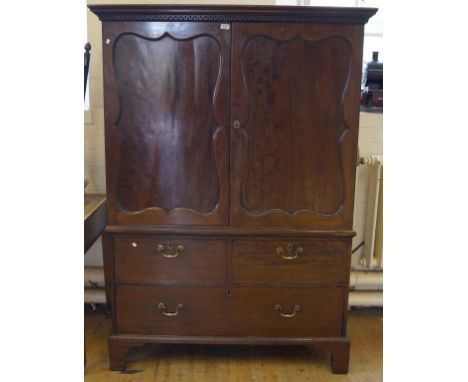 An 18th Century George III mahogany linen press of small proportionsThe swept and Greek key moulded cornice above two shaped 