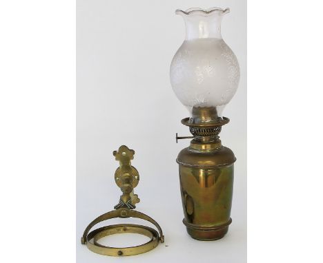 An unusual early 20th century binnacle wall lightHaving cylindrical oil lamp and frosted glass shade, having floral decoratio