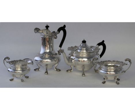 An Irish silver four piece tea service
Of circular baluster form, the flared rims with pierced Celtic scroll work, each raise