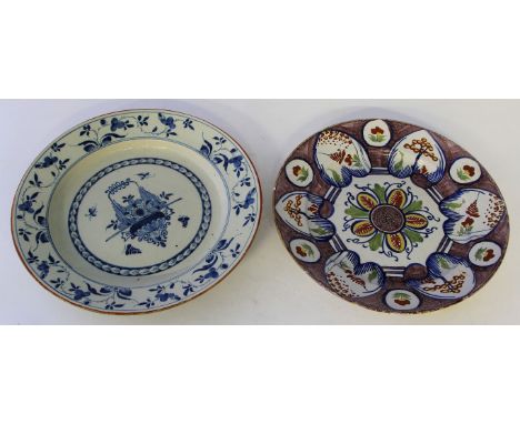 Two 18th century Delft tin glazed porcelain circular wall chargers
The first painted in multicolours to include red, yellow, 