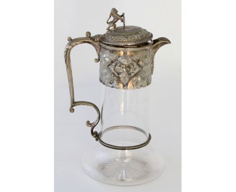 A silver plated claret jugThe plain glass jug of baluster form, the electroplated collar, lid and angular handle with leaf an