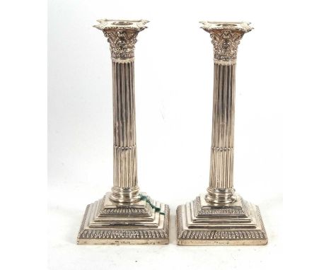 A pair of Edwarding silver candlesticks having Corinthian style columns on gadrooned stepped bases (loaded), hallmarked Sheff