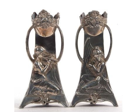 A pair of WMF Art Nouveau candlesticks of triangular form, the tops decorated with stylised flowers and each having three scr
