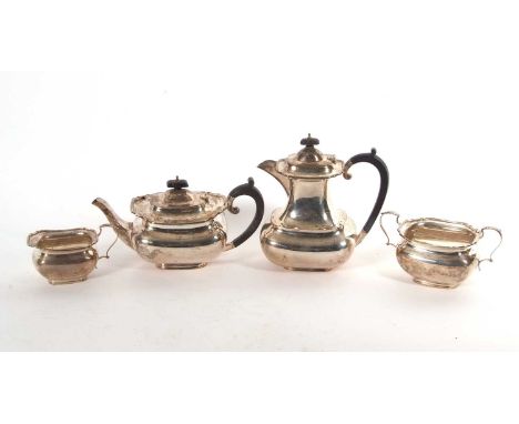 George V silver four piece tea service of plain compressed oval form with applied shaped edges comprising teapot,hot water ju