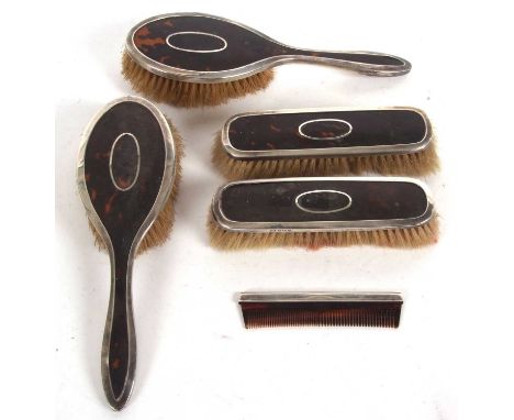 An early 20th Century silver and tortoiseshell dressing table wares comprising two hairbrushes and two clothes brushes, hallm