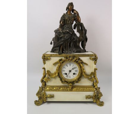 Heavy French marble mantle clock with ornate gilt decoration and a bronze alloy sculpture of a lady seated on the top, untest