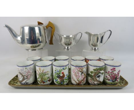 Picquot ware teapot, sugar bowl and milk plus a set of 12 Franklin porcelain oriental beakers and a tray.