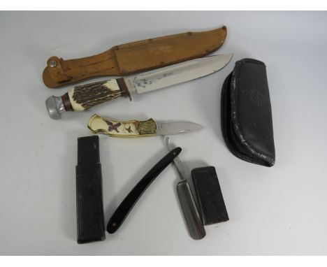Puma Hunting knife with antler handle and leather scabbard, Franklin mint pen knife and cut throat razor.