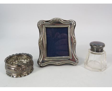 Small sterling silver photo frame 3 1/4" by 2.5", Napkin ring and bottle with silver lid.