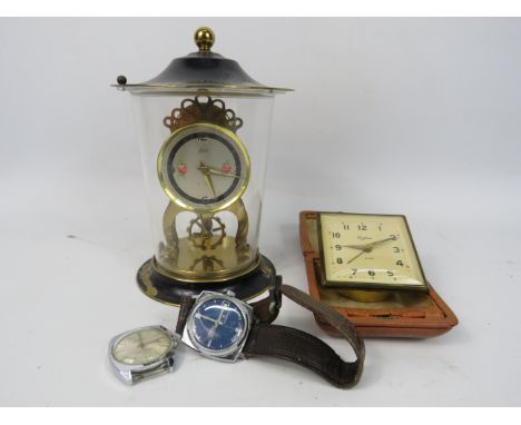 A Schatz anniversary clock in running order plus a vintage travel alarm clock and two watches for spares or repair. 