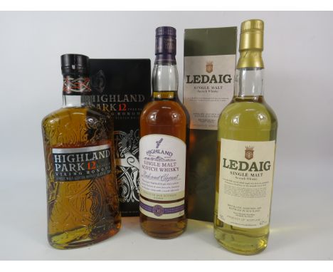 Three unopened bottles of whiskey Highland Park Viking Honor, Ledaig and Highland.