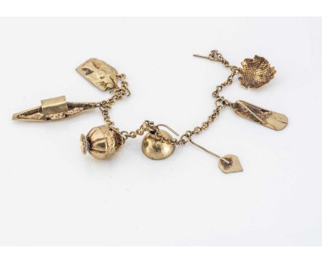 A continental early 20th Century charm bracelet, possibly Middle Eastern, various charms including a Nile boat, lantern, slip