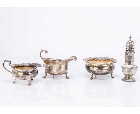 Four George V and later silver items, including a sugar basin and milk jug, a sauce boat and a sugar sifter, 23 ozt (4)