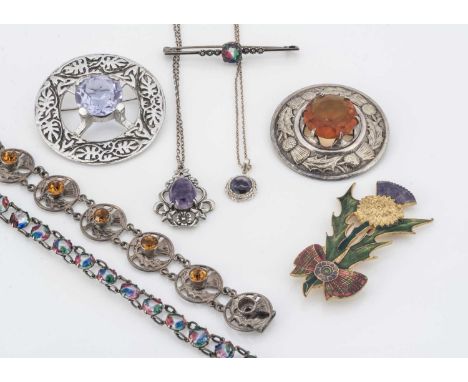 Four items of Scottish themed jewellery, including a synthetic colour change Celtic plaid brooch, another with a paste citrin