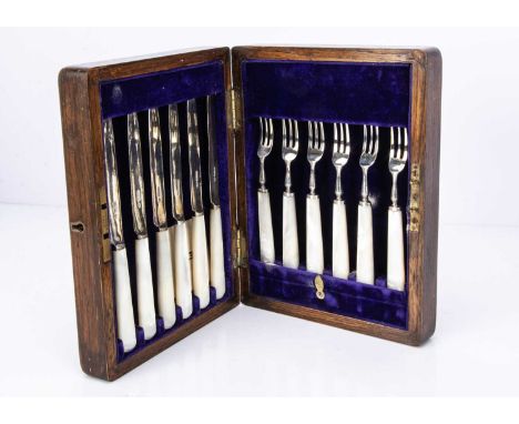 A cased George V period set of six silver and mother of pearl handled dessert knives and forks by Henry Wilkinson