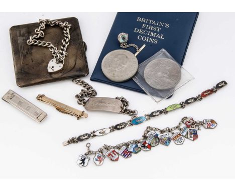 A collection of silver jewels, including a curb padlock bracelet, a continental white metal bracelet with shield enamel charm