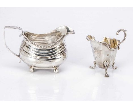 Two 19th century silver milk jugs, one Georgian helmet shaped, the other late Victorian, 7.27 ozt (2)