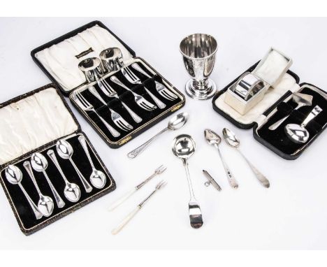 A small collection of silver items, including a cased set of silver cake forks, a cased set of six teaspoons, a pair of napki