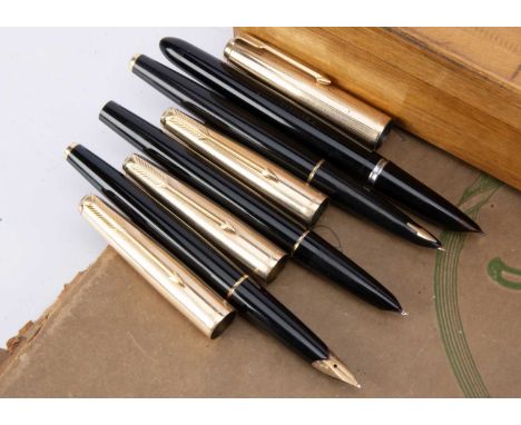 Four black Parker fountain pens, all with 12K rolled gold caps, three with gold coloured clips and mounts, one with gold colo