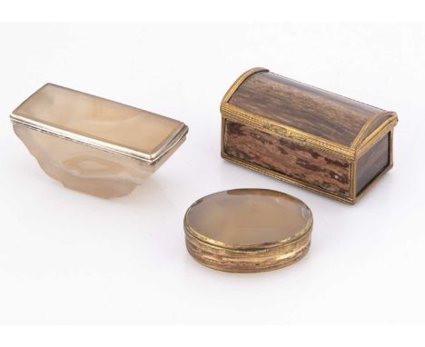 Three hardstone boxes, one light onyx example with silver rim, 6.8cm wide, a casket shaped box, and an oval hinged box, AF (3