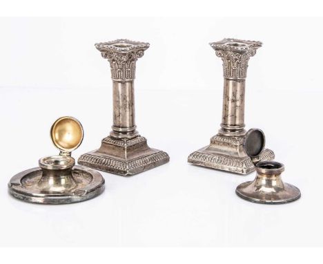 A pair of Victorian silver filled column candlesticks, together with two silver filled capstan inkwells, AF (4)
